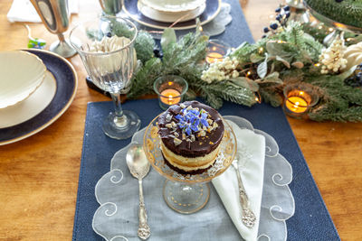 Chocolate mousse dessert and whipped cream with gold dust on a fancy crystal glass dish