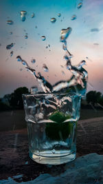 Close-up of water splashing in glass on table