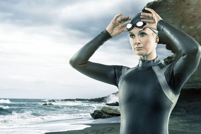 Mi adult woman in wetsuit at beach