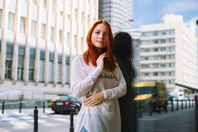 Portrait of a beautiful young woman in city