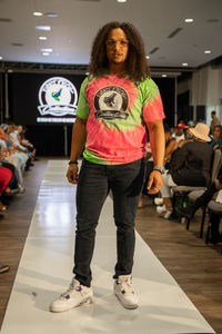 Full length portrait of smiling woman standing on floor