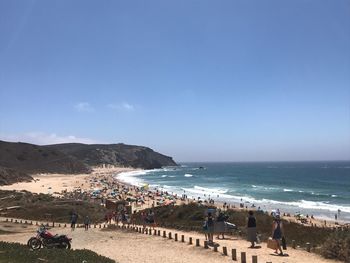 People on beach against sky