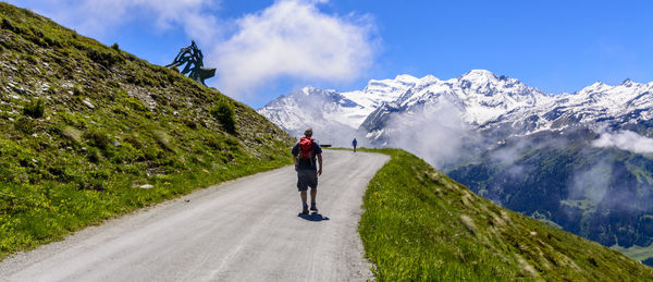 Full length of man on road in mountain landscape against sky