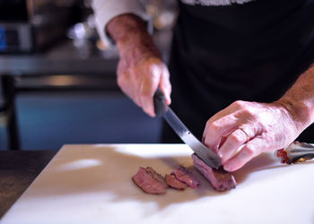 Midsection of man preparing food