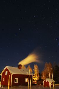 Low angle view of trees against sky at night