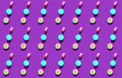 Pattern of colored macaroons on perfect purple background in vintage style. creative copy space