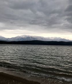 Scenic view of sea and mountains against sky