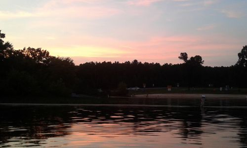 Scenic view of lake against orange sky