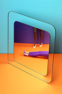 Dolls legs reflected in the mirror