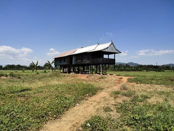 House on field against sky