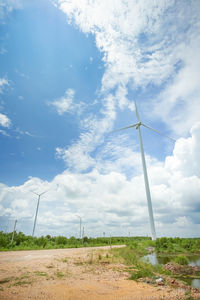 Windmill on field against sky