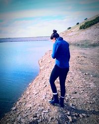 Full length of woman standing on shore