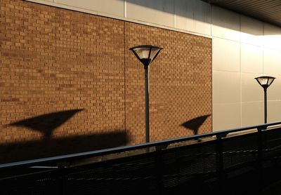 Shadow of railing and lights on wall