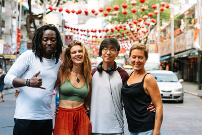 Portrait of smiling young couple standing in city