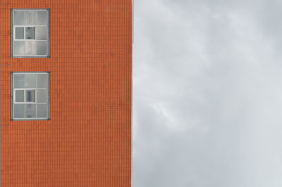 Low angle view of building against cloudy sky