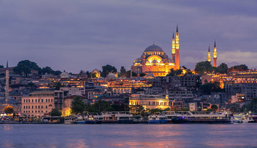 Illuminated city at waterfront