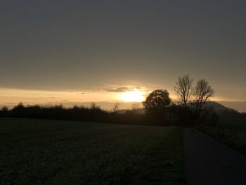 Scenic view of field against sky during sunset