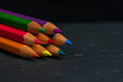 Close-up of multi colored pencils on table