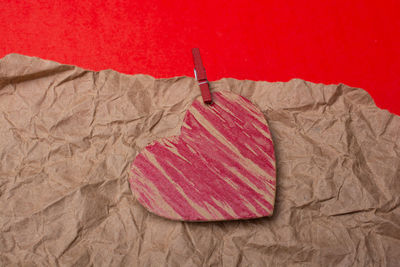 Close-up of clothes drying on bed against red background