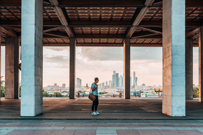 Rear view of man standing on bridge