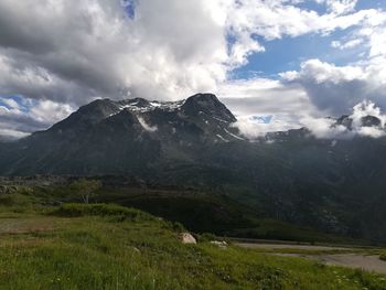 Scenic view of mountains against cloudy sky