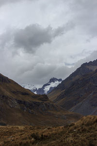 Scenic view of mountains against cloudy sky