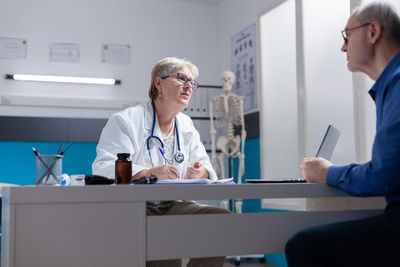 Female doctor examining x-ray at clinic