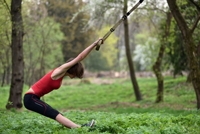 Mid adult woman exercising at public park