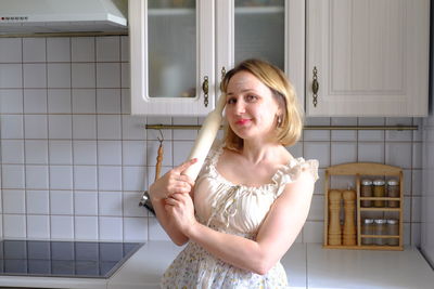 Portrait of young woman standing in bathroom