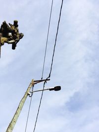 Low angle view of telephone pole against sky