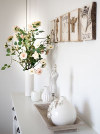 White flowers in vase on table at home