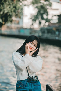 Portrait of smiling young woman standing outdoors