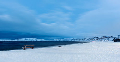 Snow covered field against sky