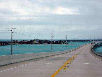 Road by sea against sky