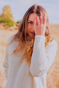 Portrait of beautiful young woman standing outdoors