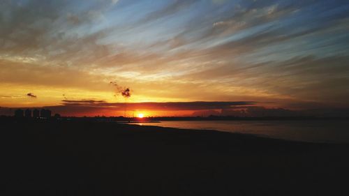 Scenic view of beach against sky during sunset