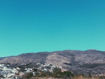 Scenic shot of mountain range against clear blue sky