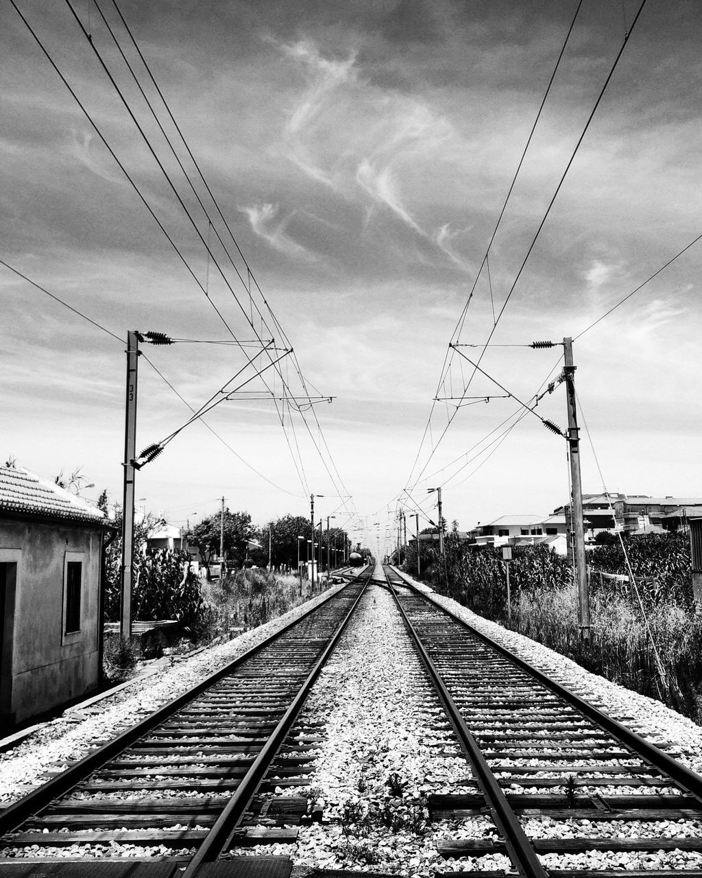 railroad track, rail transportation, power line, transportation, the way forward, sky, electricity pylon, diminishing perspective, electricity, vanishing point, public transportation, cable, connection, power supply, cloud - sky, railway track, railroad station platform, railroad station, fuel and power generation, cloud