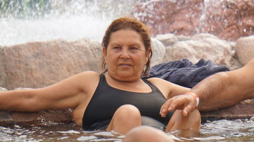 Mature woman looking away in water