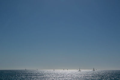 View of calm sea against clear blue sky