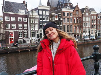 Portrait of a smiling young woman in canal