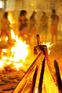 Close-up of people on bonfire at night