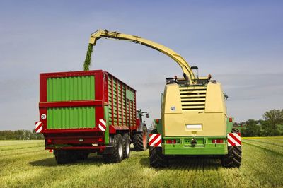 Tractor on agricultural field against sky