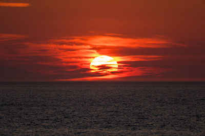 Scenic view of sea against romantic sky at sunset