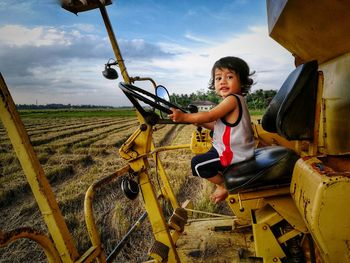 Full length of boy in farm against sky