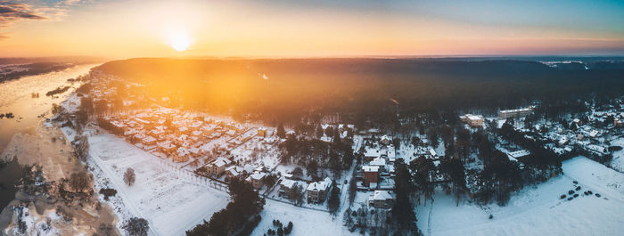 Panoramic view of frozen landscape against sky during sunset