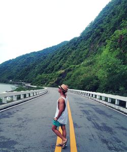 Tourist standing on winding road