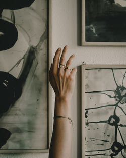 Close-up of woman hand against wall