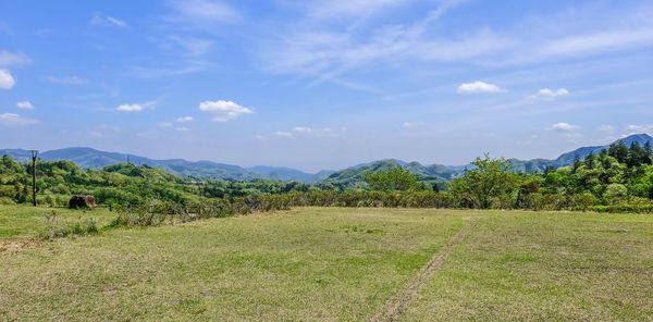 Scenic view of landscape against cloudy sky