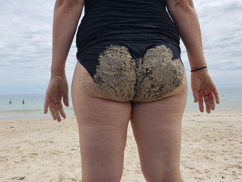 Rear view of man standing on beach